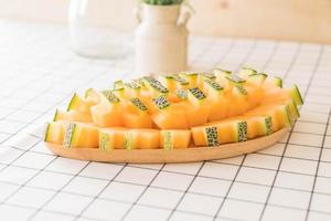 Fresh cantaloupe melon for dessert on table photo