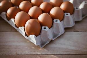 Eggs in paper boxes placed on wooden floors photo