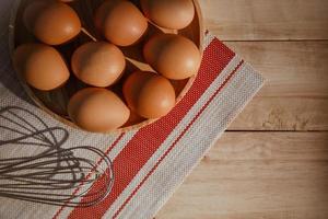 eggs in a wooden bowl. close up, top view, horizontal photo