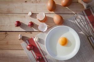 Eggs lay on wooden trays and have broken eggs. photo