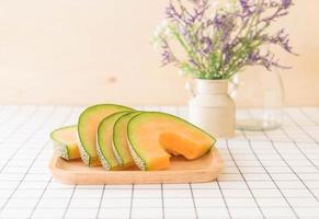 Fresh cantaloupe melon for dessert on table photo