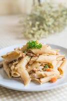 Penne pasta cream cheese on table photo