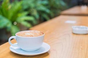 Hot caramel macchiato in coffee shop photo