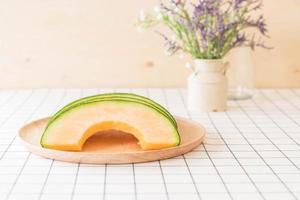 Fresh cantaloupe melon for dessert on table photo