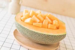 Fresh cantaloupe melon for dessert on table photo