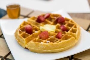 Butter waffle with honey and strawberry - dessert photo