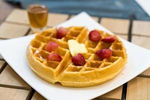 Butter waffle with honey and strawberry - dessert photo