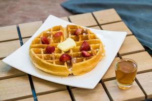 Butter waffle with honey and strawberry - dessert photo