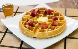 Butter waffle with honey and strawberry - dessert photo