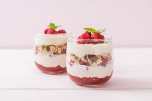 Fresh raspberry and yogurt with granola - Healthy food style photo