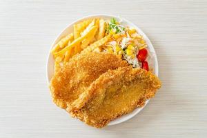Fish and chips with mini salad on white plate