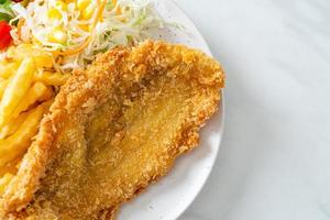 Fried fish fillet and potatoes chips with mini salad photo