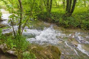 Plitvice Lakes National Park waterfall flows over stones Croatia. photo