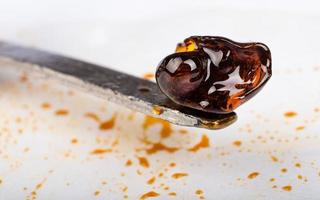 scraping high thc medical cannabis wax resin concentrate photo