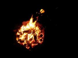 View from above of a bonfire and sparks are flying towards the camera photo