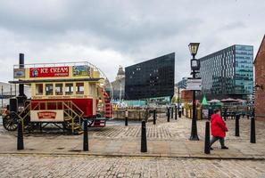 A passer by and a classic ice-cream van at the Liverpool Docks, Port of Liverpool, UK