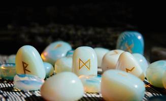 Close up of rune stones on wooden table. occult attributes photo