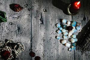 Wooden table with occult attributes, top view. Rune stones photo