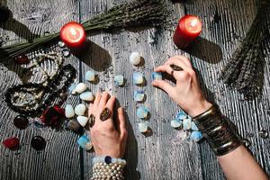 Fortuneteller's hands with stone runes, Prediction of the future. photo