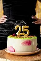 Golden candles 25 on birthday cake photo