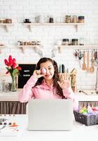 woman greeting her friends online, celebrating easter photo