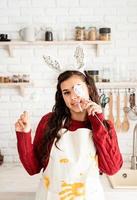 woman in rabbit ears covering eyes with easter eggs decorations photo