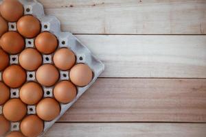 Eggs in paper boxes placed on wooden floors photo
