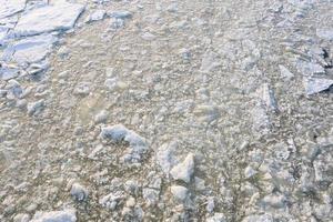 broken ice floe covered with snow with a textured surface photo