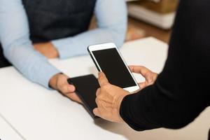 People using smartphone mobile banking scan QR code to pay in shop photo