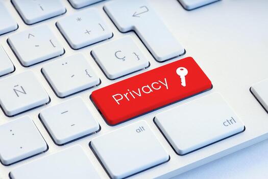 Privacy word and key icon on red computer keyboard photo