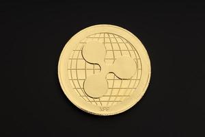 Ripple coin isolated on black background. Cryptocurrency. Top view photo