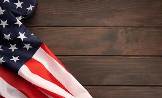 American flag on rustic wooden tabletop with copy space. Top view photo