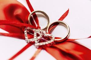 Wedding rings and red ribbon photo