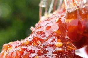 Close up chilli sauce on table, macro chilli sauce photo