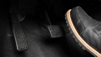 Man foot and accelerator and brake pedal inside the car photo