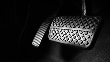 Man foot and accelerator and brake pedal inside the car photo