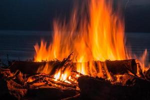 Campfire at twilight on beach photo