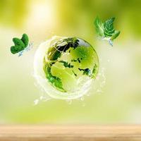 Glass globe on green moss in nature concept photo