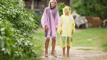 Brother and Sister Is Splashing Water in A Puddle on A Rainy Day video