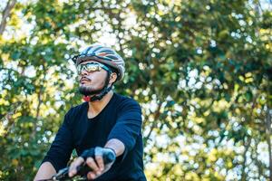 Mountain cyclists sit on bicycles and look to the front. photo