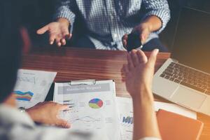 Close-up of  Team Business people discussing a financial at office. photo