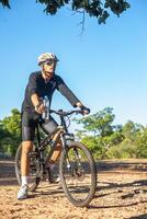 Mountain cyclists sit on bicycles and carry water bottles photo