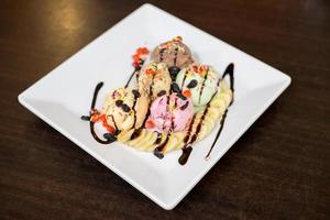 ice cream sundae vanilla strawberry chocolate  scoops with banana. photo
