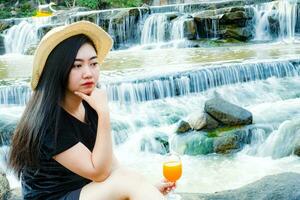 Portrait women hand holding Freshly squeezed orange juice in glass photo