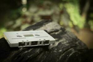 Compact cassette on table background photo