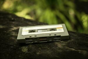 Compact cassette on table background photo