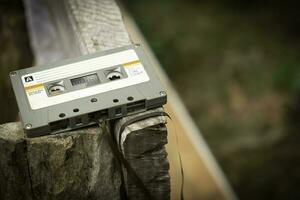 Compact cassette on table background photo