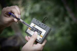 women rewind a cassette tape Vintage compact cassette photo