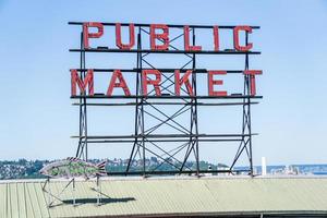 Neon public market sign against sky photo