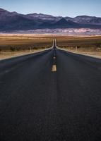 lonely empty road to deth valley national park photo